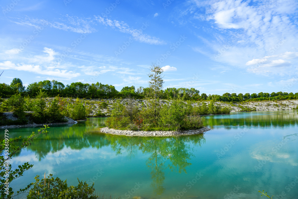 View of the Dyckerhoff lake in Beckum. Quarry west. Blue Lagoon. Landscape with a turquoise blue lake and the surrounding nature.
