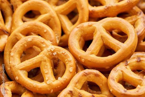 closeup mini salted pretzel in a wooden plate on wood table background.                                                                                                                                