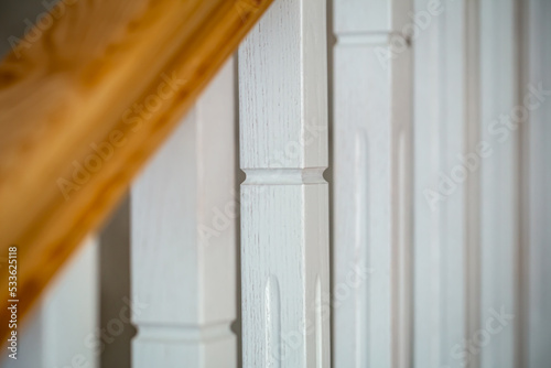 Wooden white staircase in the interior of the house  detail.