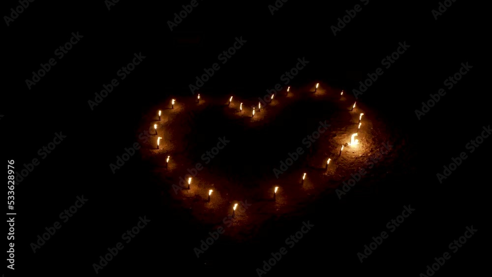 Fire heart of burning torches flickering in darkness, aerial view. Fire heart of burning torches flickering in darkness, aerial view.