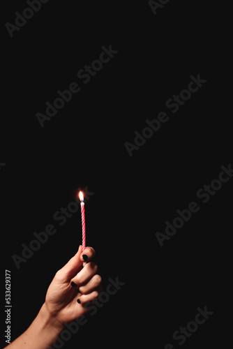 hand with birthday candle