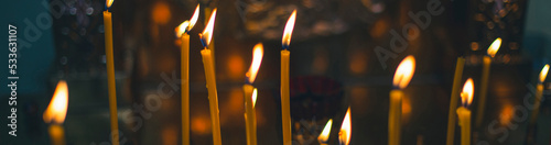 Canvas-taulu church candles close-up, against the background of a specially blurred religious