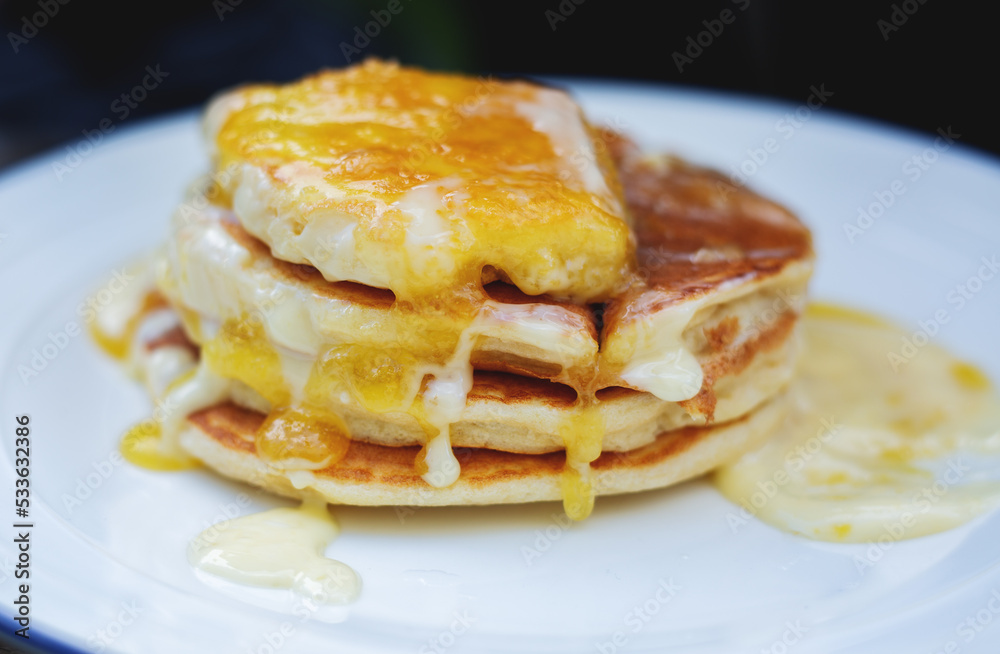 Delicious pancakes with honey and butter