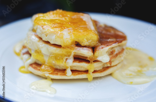 Delicious pancakes with honey and butter