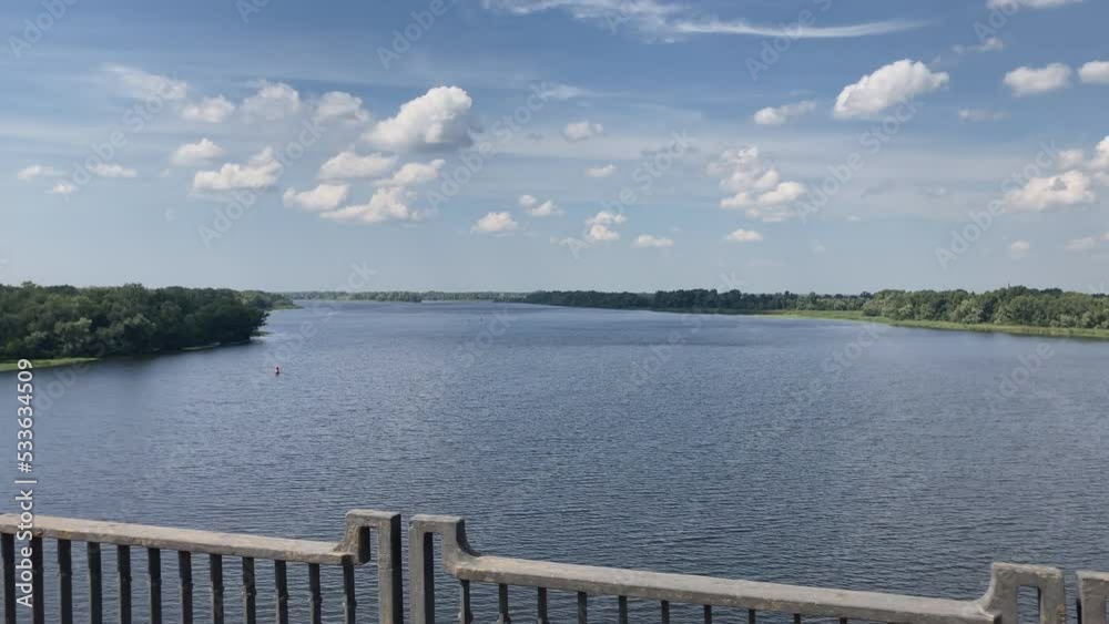 a beautiful view from the bridge to the river and the sky from a moving car. travel concept