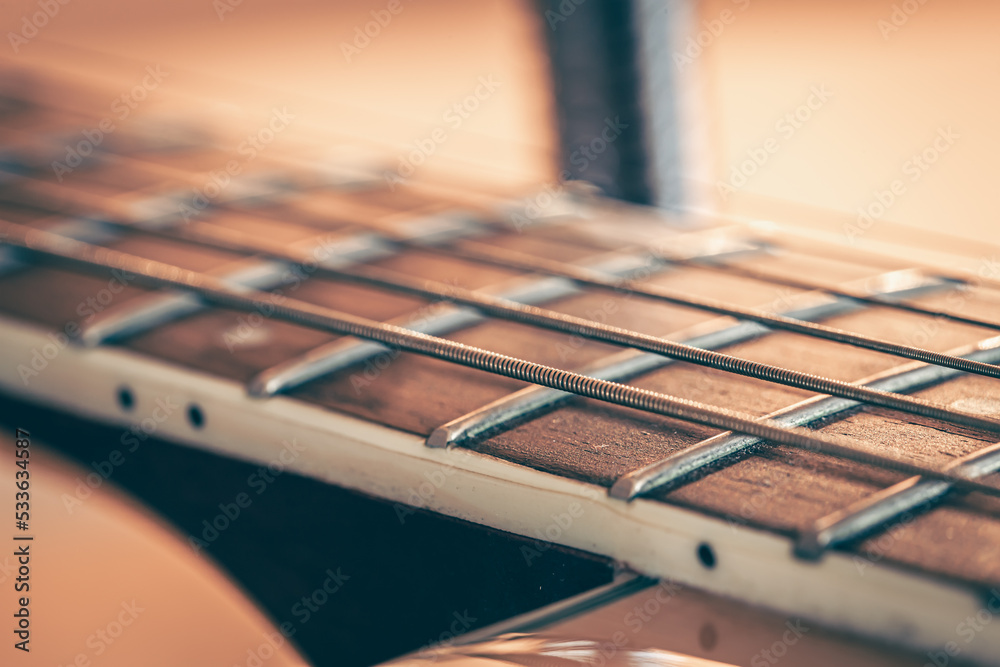 Guitar neck with a metal string, macro photography. Guitar neck with a metal string, macro photography.