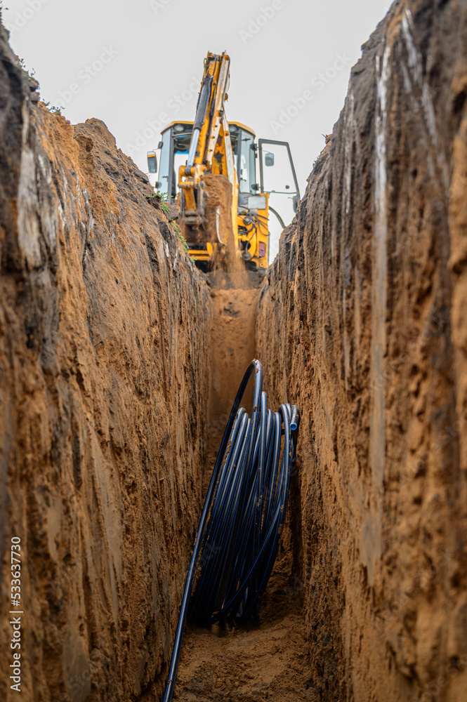 Installation of HDPE pipes in the trench. The process of laying of