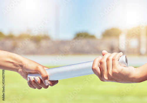 Fitness, hands and relay for athletics of people in teamwork for running competition, sports and exercise. Hand of fit athlete team passing baton in athletic sport for healthy training in nature photo