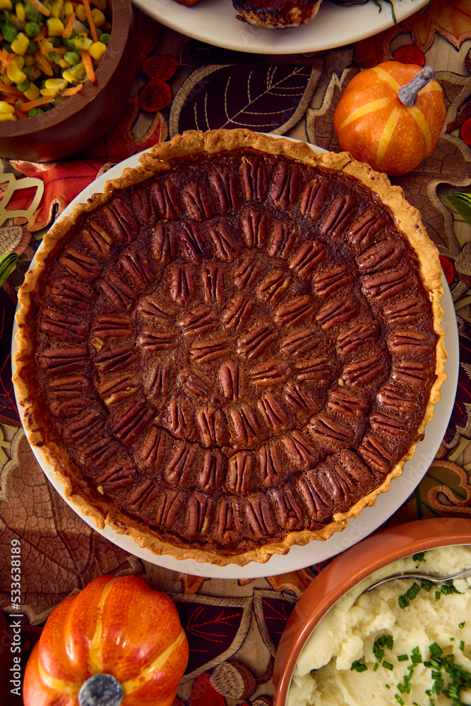 Overhead Shot Of Table Set For Thanksgiving Meal With Pumpkin Pie Topped With Pecans Overhead Shot Of Table Set For Thanksgiving Meal With Pumpkin Pie Topped With Pecans