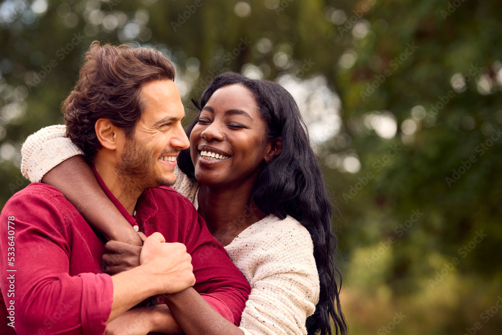 Loving Mixed Race Couple Leaning On Fence On Walk In Countryside Loving Mixed Race Couple Leaning On Fence On Walk In Countryside