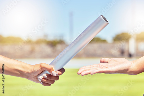 Teamwork, sports and hands of runner with relay race with baton in field stadium event for health, training or fitness. Partnership, goal and support with athlete running in exercise or competition