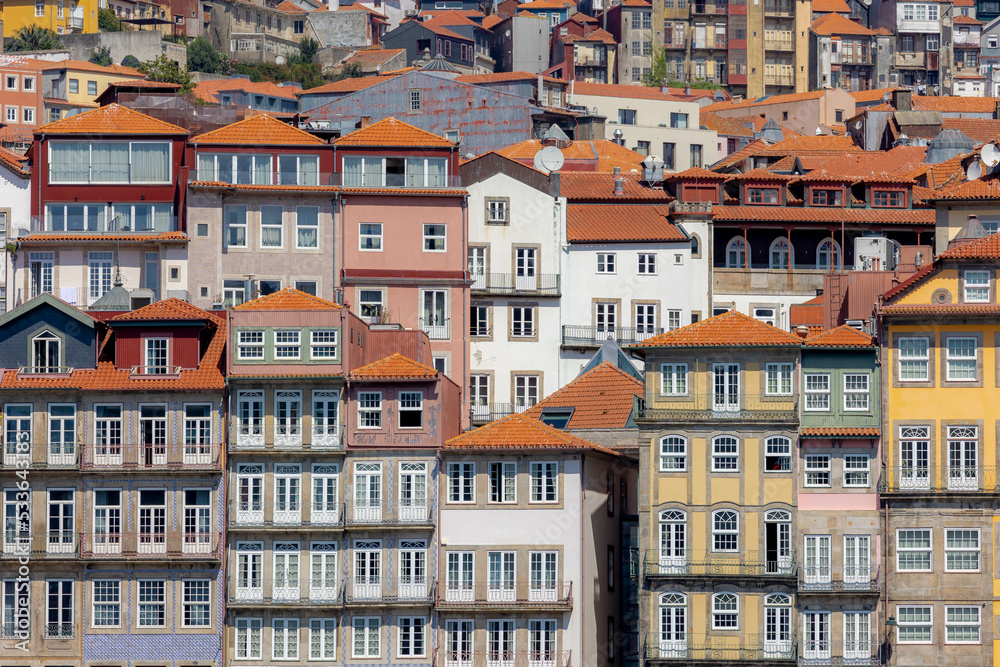 Summer cityscape, Narrow cobbled streets and houses in Porto, 
A coastal city in northwest Portugal known for its stately bridges and port wine production in the medieval Ribeira (riverside) district.