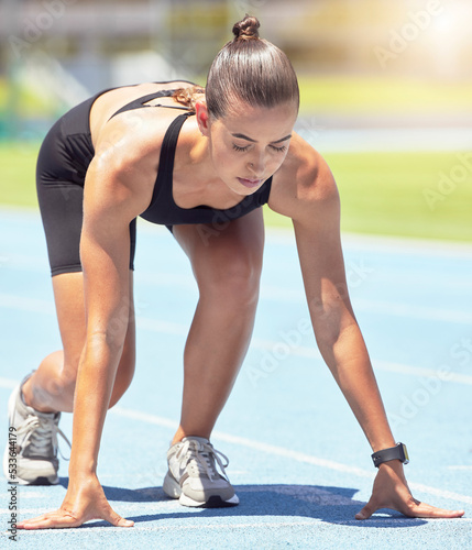 Runner, woman and focus of a athlete about to start a run on a sport track outdoor. Fitness, sports and motivation for workout training for running in a exercise for healthy living and strong cardio