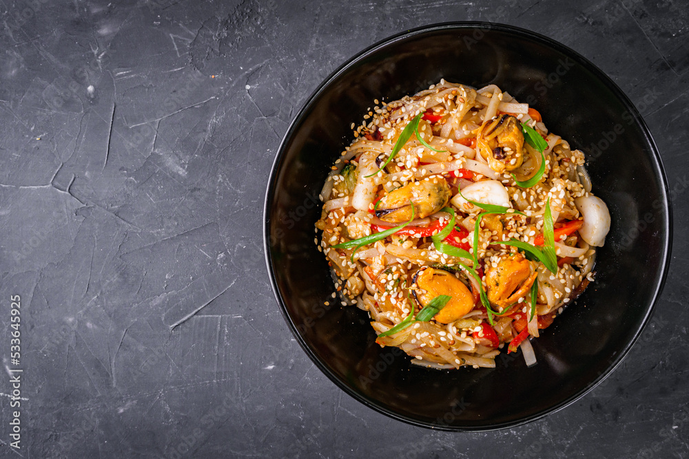 delicious chinese fried noodles on a black background delicious chinese fried noodles on a black background