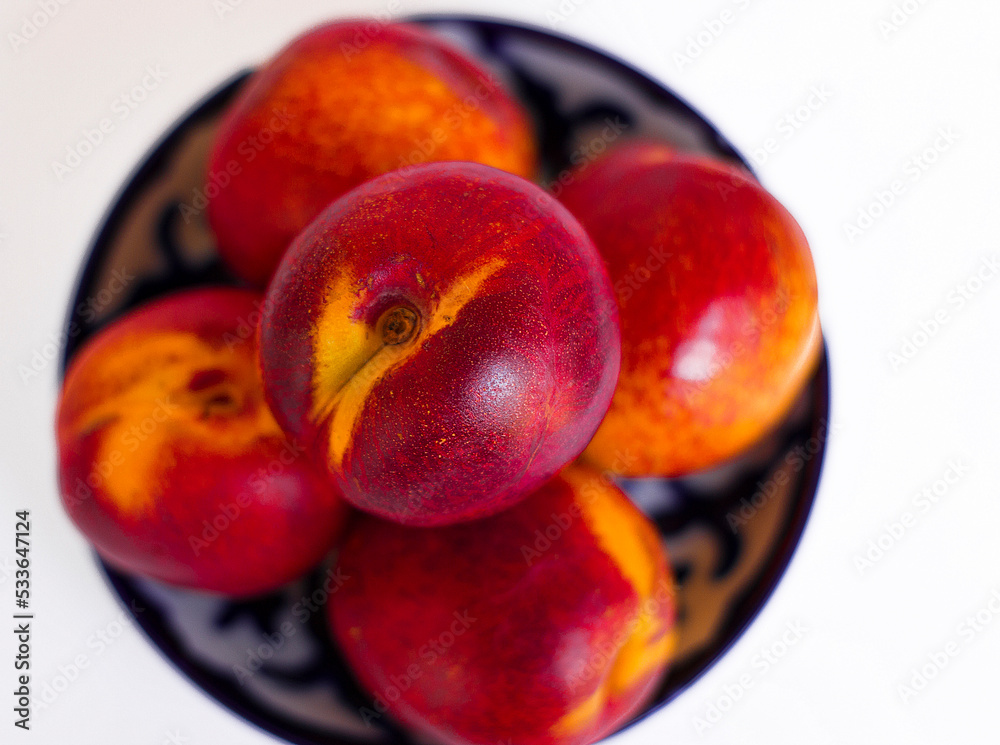 peaches in a plate on a white background
