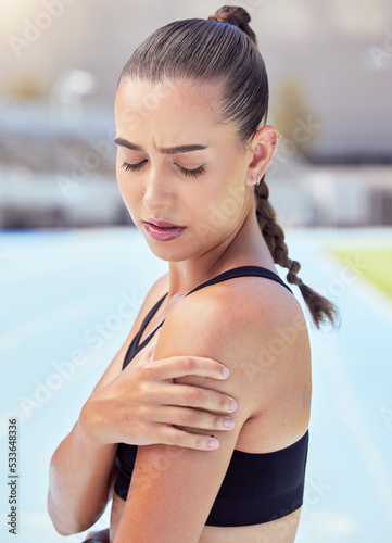 Woman athlete hands shoulder pain, emergency health risk and muscle strain during workout, training and exercise. Closeup of female runner touching pulled muscle, arm injury and sore outside on track