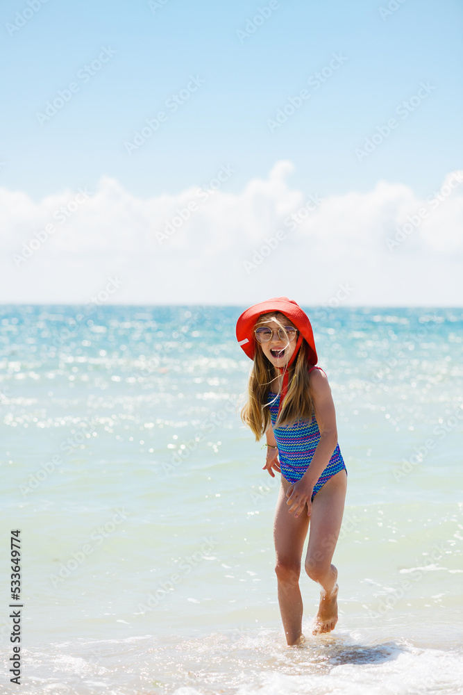 Little girl look back at beautiful sea