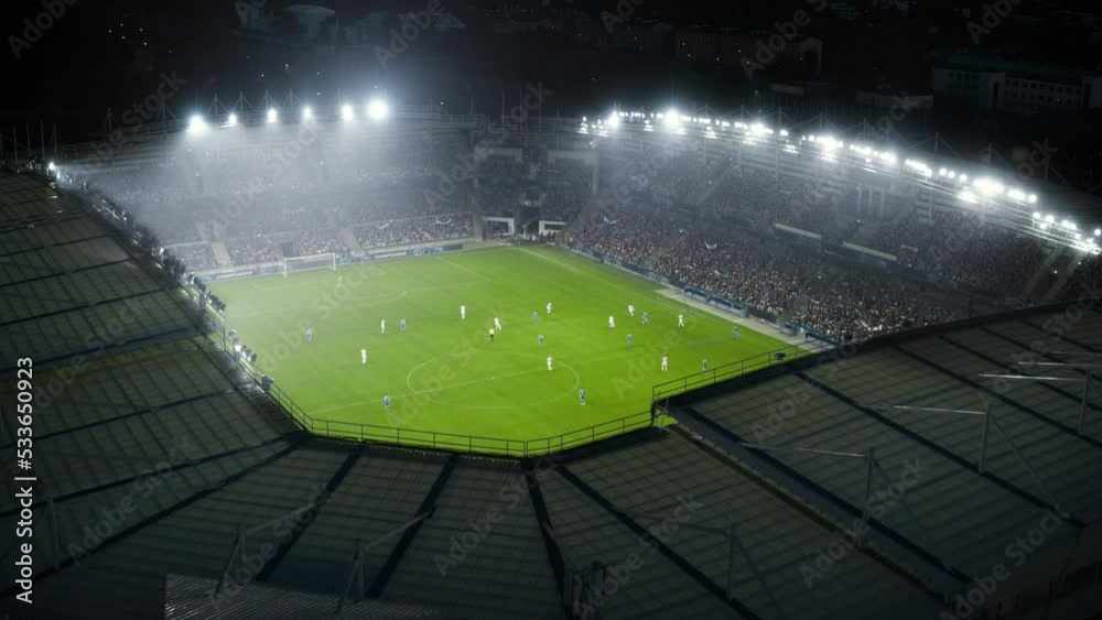 Aerial Establishing Shot of a Whole Stadium with Soccer Championship Match. Teams Play, Crowds of Fans Cheer. Football Tournament, Cup Broadcast. Sport Channel Television Playback, Screen Content
