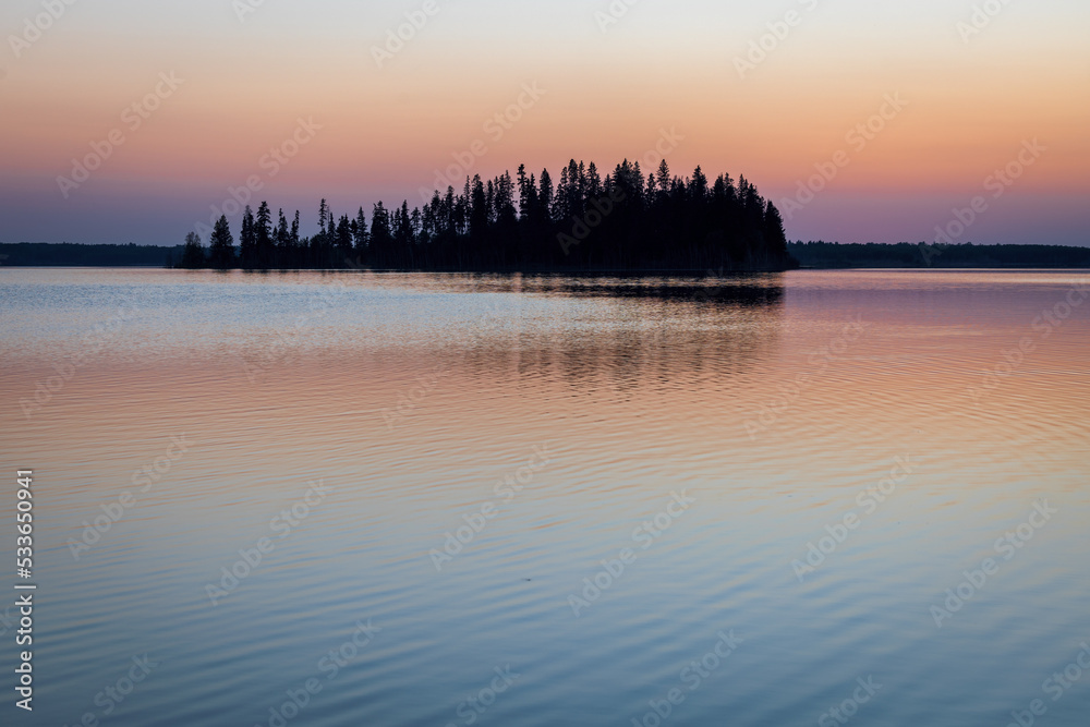 Minimalistic and colorful sunset over lake Astotin, Elk Island National Park, Alberta, Canada