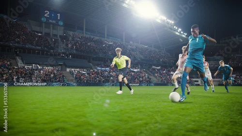 Professional Soccer Football Match Championship: Blue Team Attacks, Black Forward Masterfully Dribbles on an International Tournament. Stadium of Fans Cheers. Cinematic Playback in Slow Motion