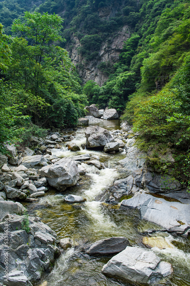 Wild stream brook through through the rocks of a mountain Wild stream brook through through the rocks of a mountain