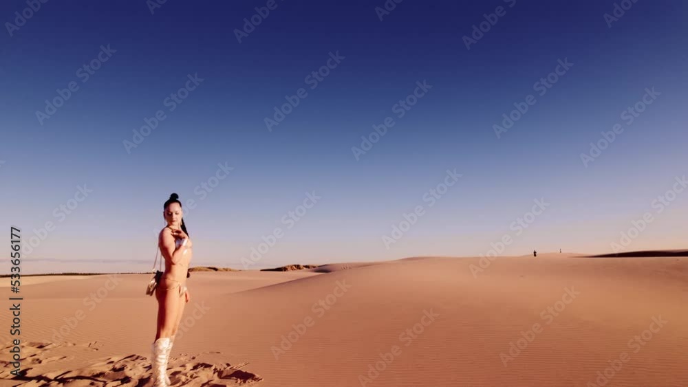 Drone Of Woman In Bikini Standing In Hot Desert Sand Drone Of Woman In Bikini Standing In Hot Desert Sand