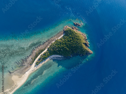 High angle aerial drone view of Langford Island, a small islet next to Hayman Island, a luxury resort hotel in the Whitsunday Islands group near the Great Barrier Reef in Queensland, Australia.