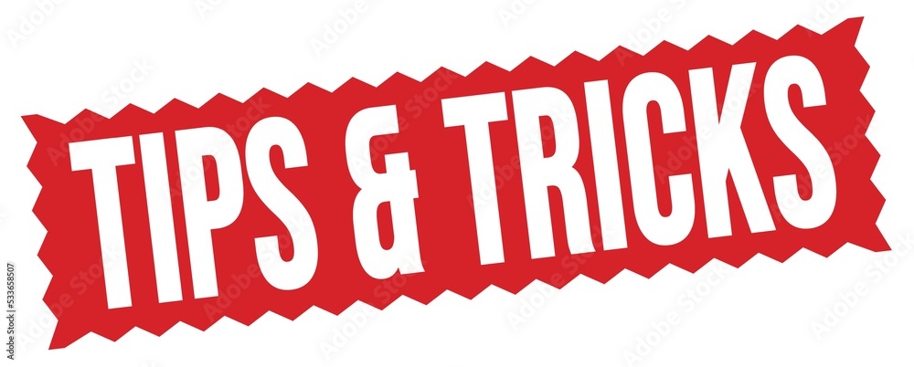 TIPS & TRICKS text written on red stamp sign. TIPS & TRICKS text written on red stamp sign.