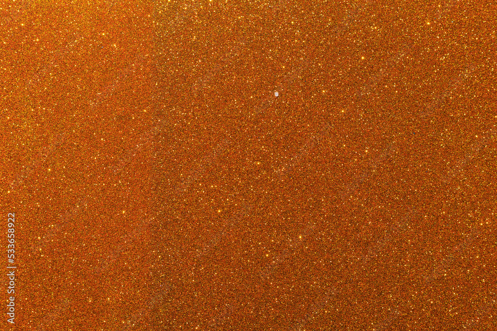 Background with sparkles. Backdrop with glitter. Shiny textured surface. Dark orange Brown tone