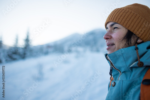 woman with a backpack in a winter hike