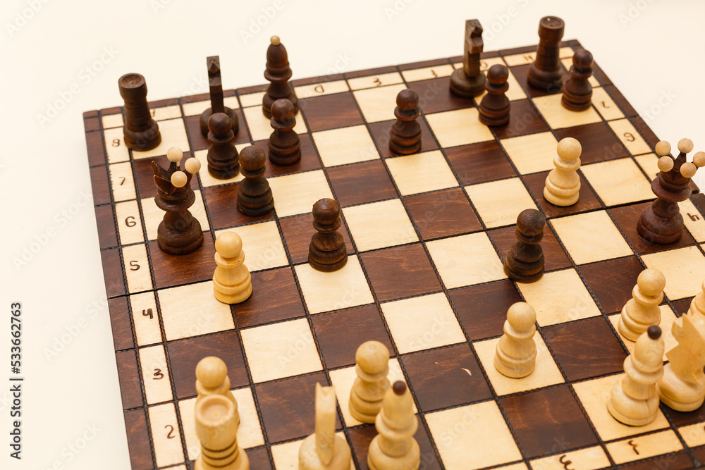 Chess board with chess wooden pieces isolated on white Chess board with chess wooden pieces isolated on white
