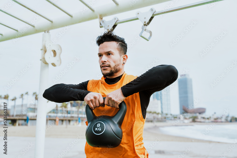 Young athlete training in the morning on the beach at the gym. outdoor. Representation of sport and healthy lifestyle concepts - obrazy, fototapety, plakaty 