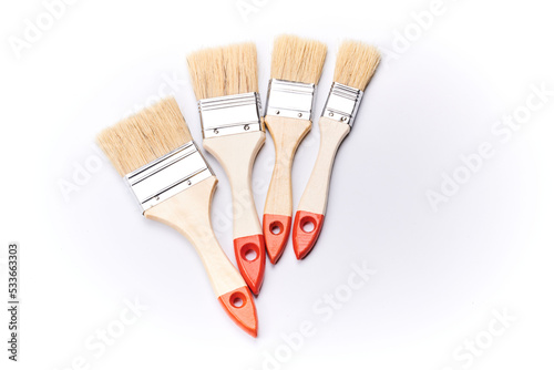 New clean wooden paint brushes isolated on white background closeup