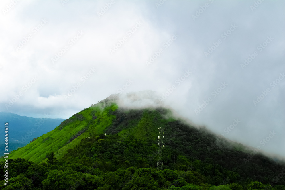 Spectacular view of Mullayanagiri peak covered with fog in Chikmagalur,Karnataka,India