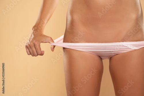 A woman showing her waxed bikini area. photo