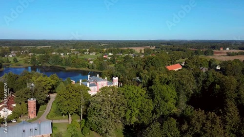 Aerial View of the Birinu Palace. Latvian Castle by Lake With Nice Garden, Drone Shot. Birini Manor, Vidzeme Region, Latvia. Sunny Autumn Day photo