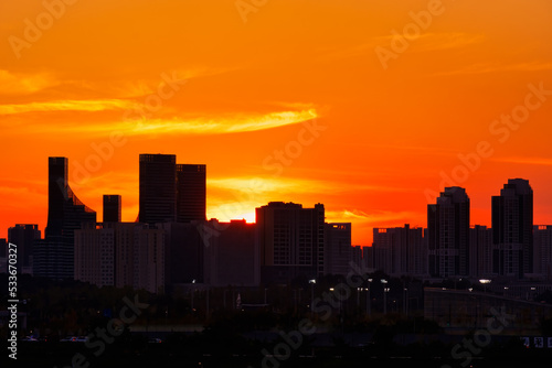 Scenic view of the city against sky during sunset
