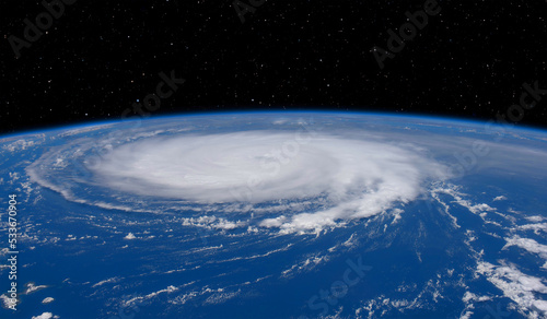 Fototapeta Naklejka Na Ścianę i Meble -  Giant hurricane seen from the space at sunset 