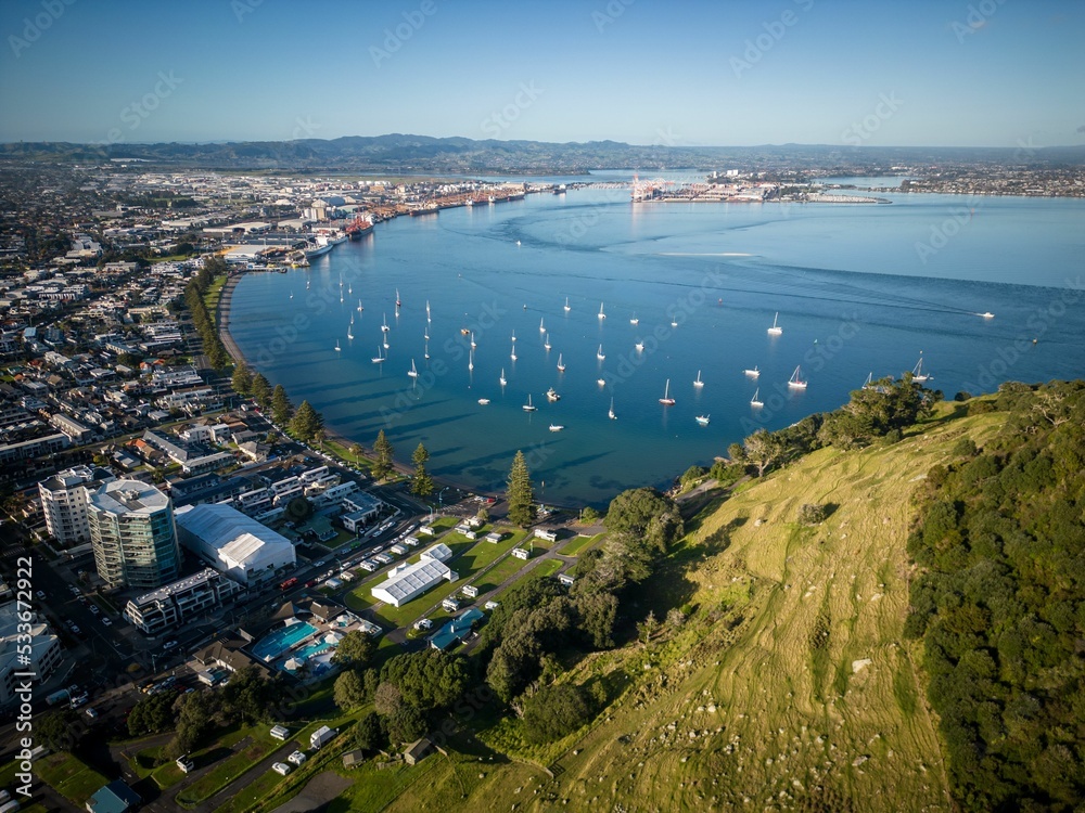 Naklejka premium Aerial view of Mount Maunganui with Bay of Plenty and modern buildings, Tauranga, New Zealand