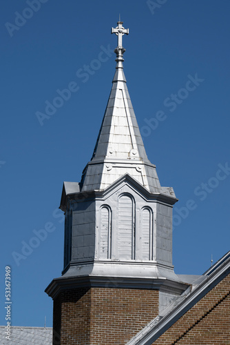 A beautiful catholic church bell tower on a blue sky