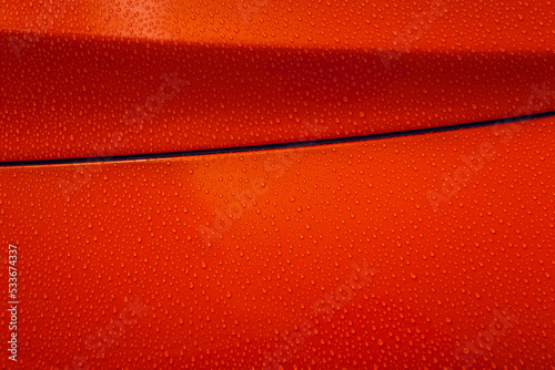 Gouttes d’eau sur carrosserie de voiture rouge photo