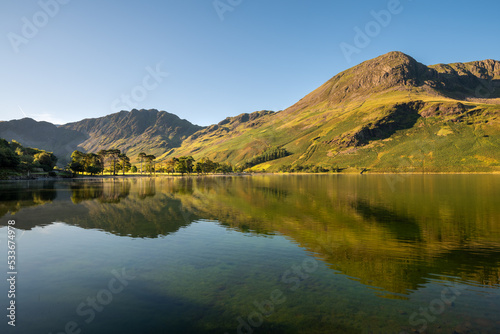 Lake District mountains reflecting in calm water at Buttermere.