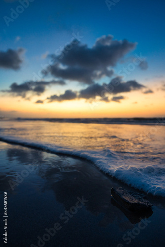 Beautiful sunset sunrise at the beach with dramatic clouds in the blue purple yellow sky over the sea - Bali © Hanjin