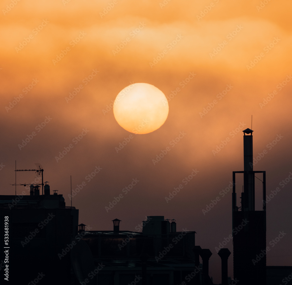 sunrise over the chimneys of the city