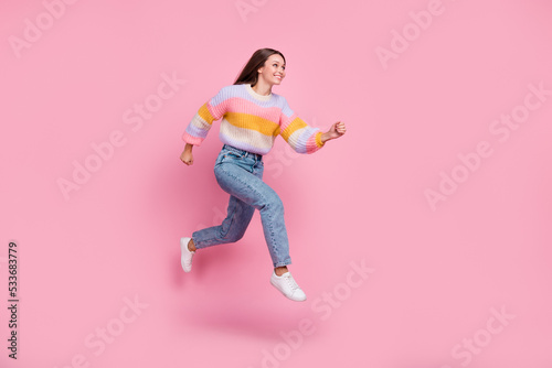 Full length profile portrait of active excited girl jump rush look empty space isolated on pink color background