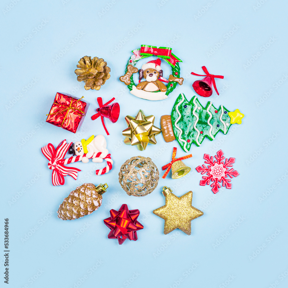 Christmas composition. Christmas gifts, decor, toys on a blue background in the form of a circle. Flat lay, top view.
