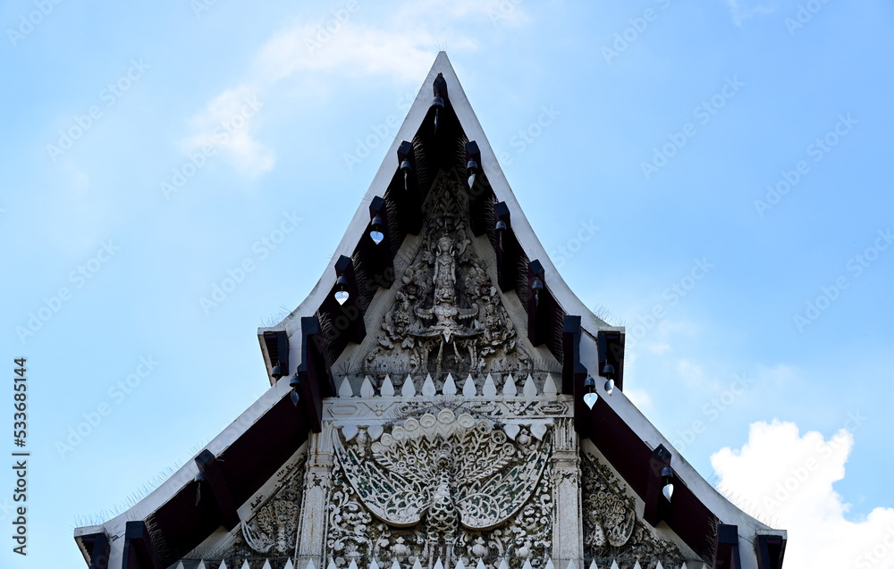BANGKOK, THAILAND - September 26, 2022 : Part of the Roof of a temple in Thailand. Traditional Thai style pattern on the roof of a temple with Blue Sky Background. BANGKOK, THAILAND - September 26, 2022 : Part of the Roof of a temple in Thailand. Traditional Thai style pattern on the roof of a temple with Blue Sky Background.