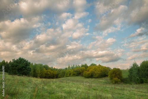 Landscape autumn sunset or sundown field with colourful clouds  autumn Poland  Europe and amazing blue sky with clouds