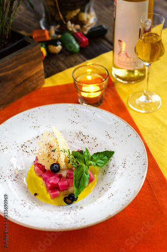 Tuna with sauce and wine in restaurant