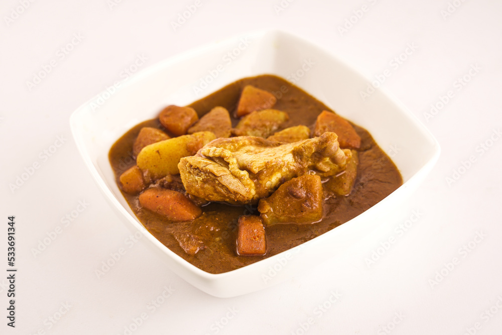 Chicken curry with potato on whitw background. Chicken curry with potato on whitw background.
